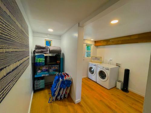 a laundry room with a washer and a washing machine at Private Wine Country-River Bungalow! Sunny Treetop Views - Pets Stay Free in Forestville