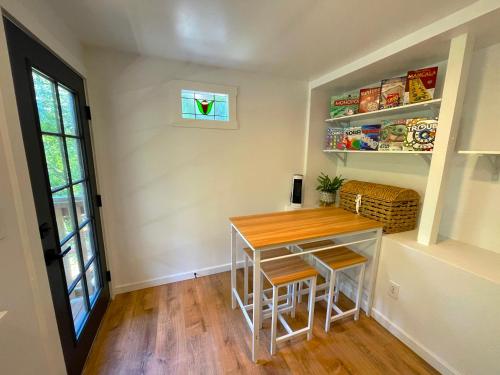 a small kitchen with a table and two stools at Private Wine Country-River Bungalow! Sunny Treetop Views - Pets Stay Free in Forestville