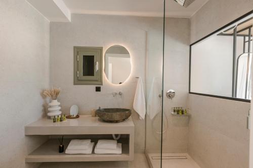 a bathroom with a sink and a glass shower at Villa Sensi in Lixouri