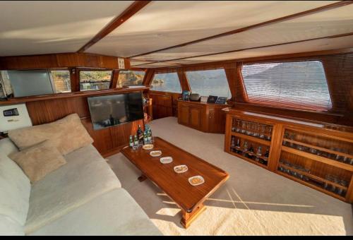 a living room of a boat with a couch and a table at Göcek Bays and Islands in Fethiye