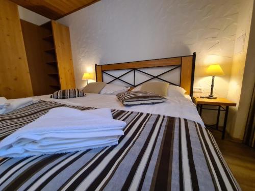 a bedroom with two beds with towels on them at CHALET ASKALA JASNÁ in Demanovska Dolina