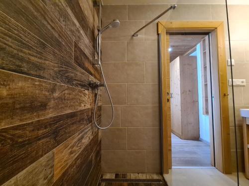 a bathroom with a shower built into a wall at CHALET ASKALA JASNÁ in Demanovska Dolina