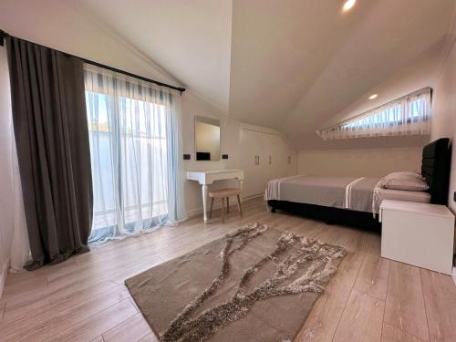 a bedroom with a bed and a desk in it at HACI BEY VİLLALARI in Kemer
