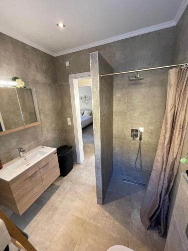 a bathroom with a shower and a sink and a shower at Villanet SeaView Halkidiki in Mola Kalyva
