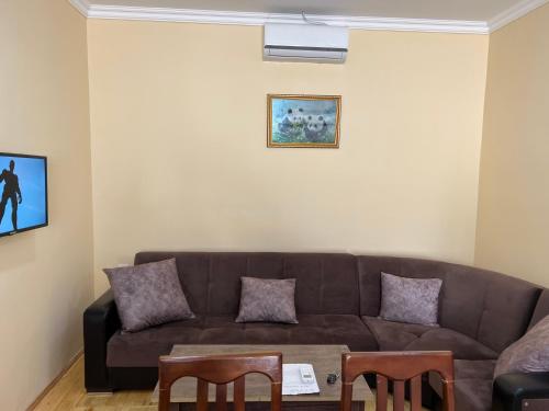 a living room with a couch and a table at Alp Hotel in Qax