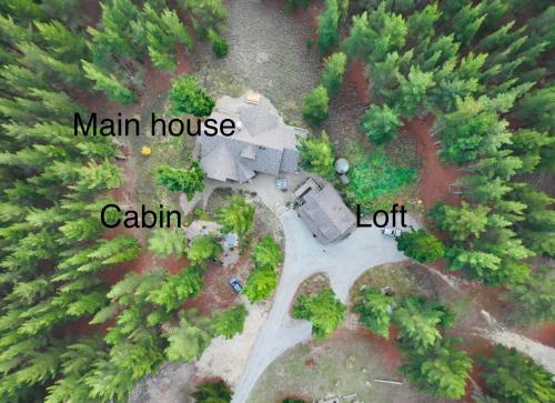 an aerial view of a mansion house with trees at Magical Loft - Homewood Forest Retreat in Alexandra