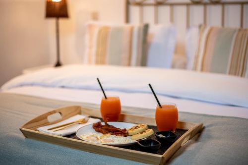 a tray of food on a table in a bedroom at Valle de Santiago Hotel Boutique in San Cristóbal