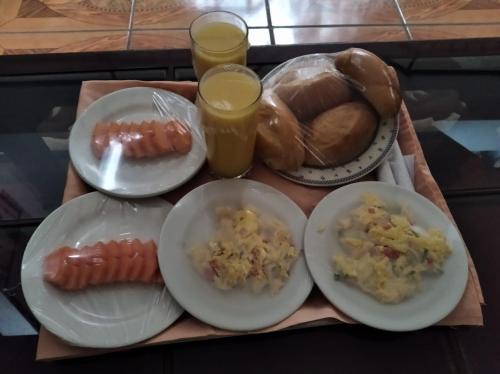 a tray of food with plates of food and bread at HOTEL REALPICO VICTORIA in Duitama