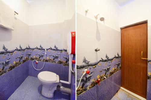 a bathroom with a toilet and a wall with birds on it at Hotel O Mango Leaf Hotel & Restaurant in Baharampur