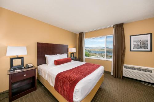 a hotel room with a bed and a window at Celilo Inn in The Dalles