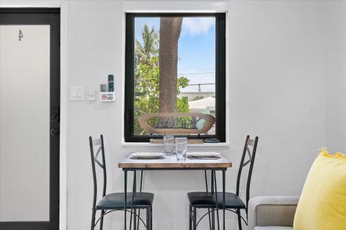 a table and chairs in a room with a window at Walnut By The Sea in Hollywood