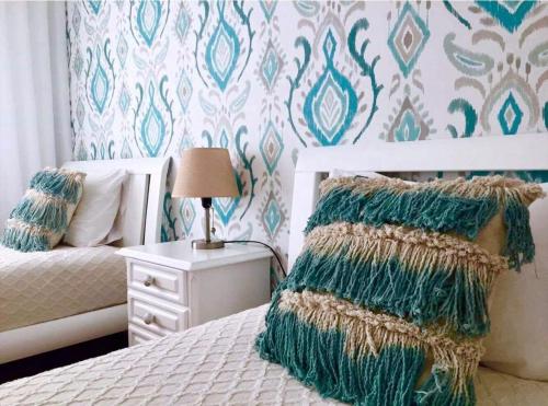a bedroom with a bed and a table with a lamp at Flipflops Ocean View in Nazaré