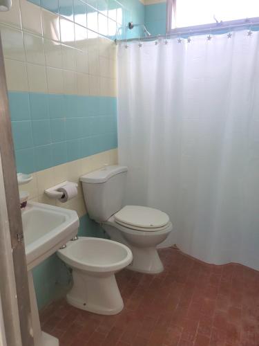 a bathroom with a toilet and a sink and a shower at SLC San Martín 2 in San Luis