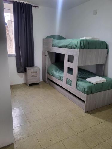 two bunk beds in a room with a tile floor at SLC San Martín 2 in San Luis