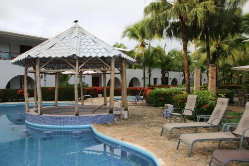 a gazebo sitting next to a swimming pool at Tropical Bliss Pool Wi-Fi BBQ Near Quepos Manuel Antonio in Quepos