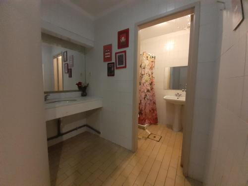 a bathroom with a sink and a mirror at City Drops Hostel Clérigos Private Room in Porto