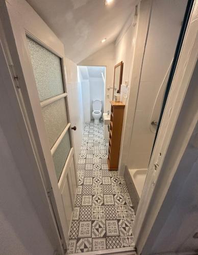 a hallway with a bathroom with a toilet and a floor at Oporto Blue Liberdade - Citycenter View Penthouse Studio in Porto