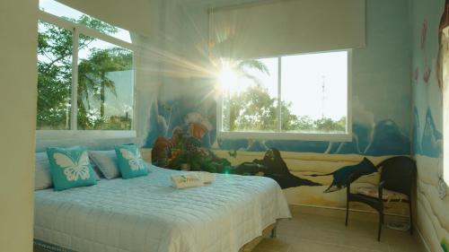 a bedroom with a bed with a dinosaur mural on the wall at Amazing Beachfront Villa - Palm House in Punta Chame
