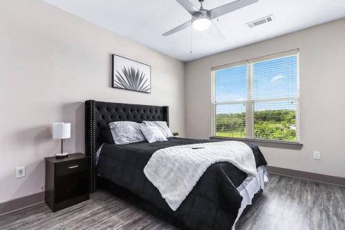 a bedroom with a black bed and a window at Luxury Buckhead Apartment in Atlanta