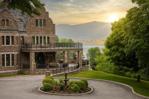 a mansion with a fountain in front of a building at The Inn at Erlowest in Lake George