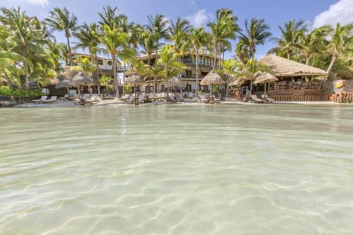 a view of a resort from the water at Beachfront Hotel La Palapa - Adults Only in Holbox Island