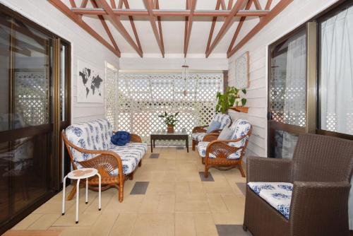 a living room with chairs and a table at Beach House Getaway - Family & Pets ZB6 in Buddina
