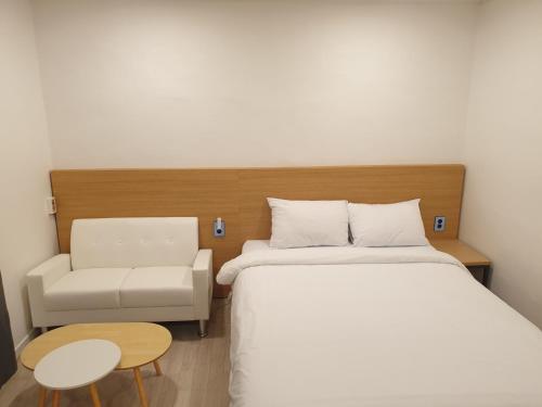a hotel room with a bed and a chair at Seorak HOT Spring Mammoth Resotel in Sokcho