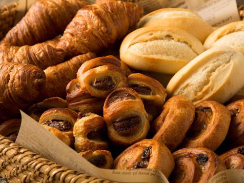 a basket of different types of bread and pastries at The Park Front Hotel at Universal Studios Japan in Osaka