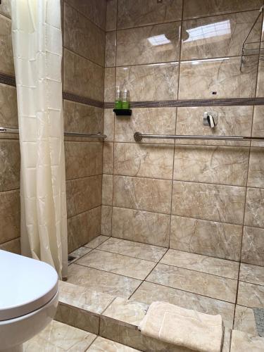a bathroom with a shower with a toilet at Cabaña Mamá Elia in Trinidad