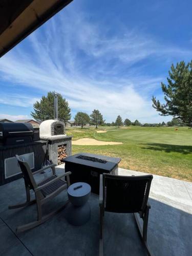 a patio with a table and chairs and a golf course at Moses Lake Golf Retreat @ Resorts At Moses Pointe in Moses Lake