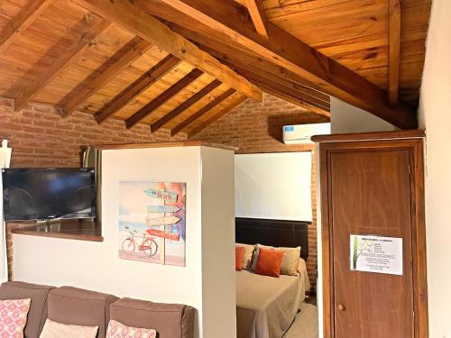 a living room with a couch and a tv at Kimbara Bosque y Mar in Mar de las Pampas