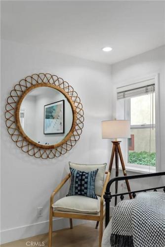 a bedroom with a mirror and a chair and a bed at Amazing location! Luxurious beach cottage.Ocean views in Manhattan Beach