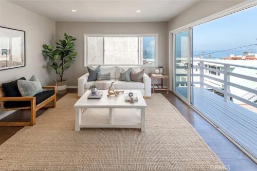 a living room with a couch and a table at Amazing location! Luxurious beach cottage.Ocean views in Manhattan Beach