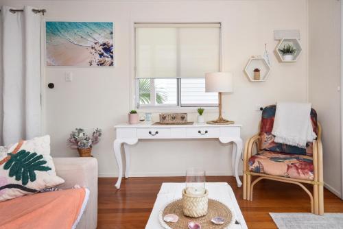 a living room with a table and a chair at Golden Beach Family & Friends Getaway ZC4 in Golden Beach