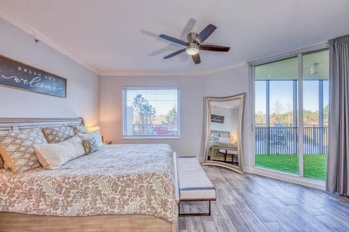 a bedroom with a bed and a ceiling fan at Foxy Palmer! 3 bedroom 2 bath in Perdido Golf Resort in Pensacola