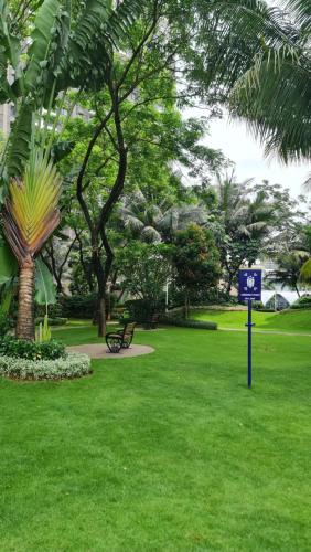 a park with a blue sign in the grass at 3Br Sky House BSD Apartment Brandnew and Cozy in Samporo
