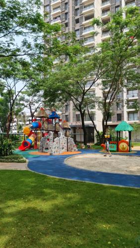 a playground in a park with children playing on it at 3Br Sky House BSD Apartment Brandnew and Cozy in Samporo