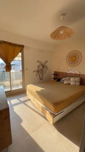 une chambre avec un lit et une grande fenêtre dans l'établissement Luxueux appartement centre, à Antibes