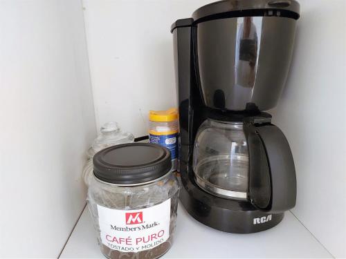 a coffee maker and a jar in a refrigerator at Habitacion 11 independiente con mucha privacidad ,cerca del consulado , CAS , a 200 mts del vado del rio in Hermosillo