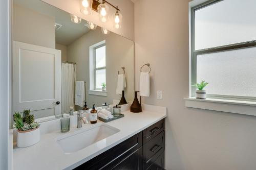 a bathroom with a sink and a large mirror at Bright Central Point Home with Deck and Mountain Views in Central Point
