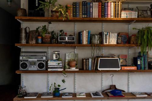 a room with wooden shelves filled with books at The Peaceful Village in Pinghe