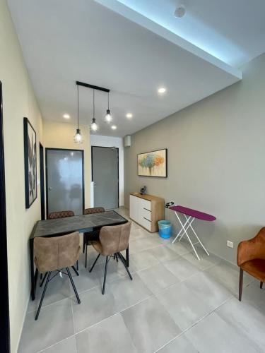 a dining room with a table and chairs at Sandakan Homestay Coastal Serenity 山海绿栖 in Sandakan