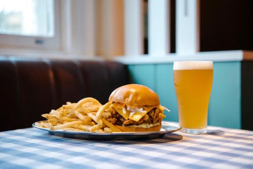 a plate of fries and a sandwich and a glass of beer at Lord Wolseley Hotel in Sydney
