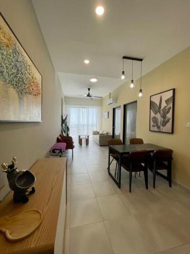 a living room with a table and a couch at Sandakan Homestay Coastal Serenity 山海绿栖 in Sandakan