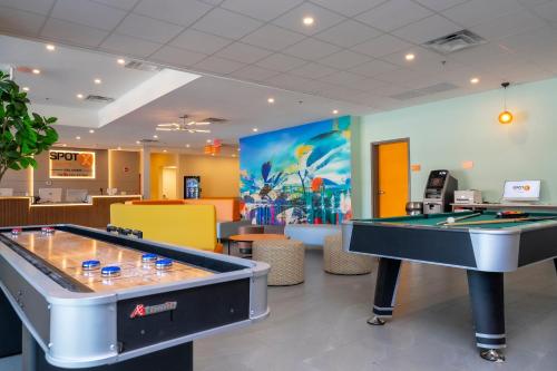 a lobby with a pool table in a store at SPOT X Hotel Orlando Intl Dr by The Red Collection in Orlando