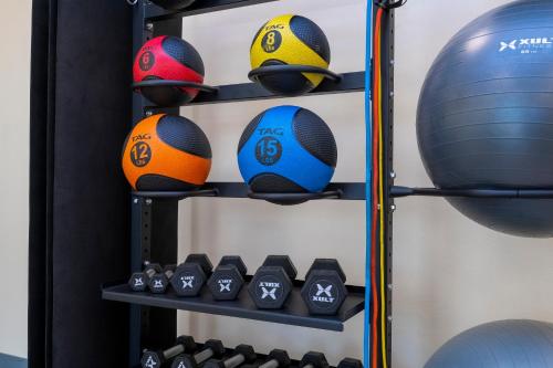 a shelf with balls and dumb balls on it at SPOT X Hotel Orlando Intl Dr by The Red Collection in Orlando