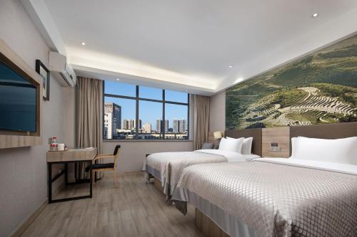 a hotel room with two beds and a large window at Morning Hotel, Loudi Changqing Street Louxing Square in Loudi