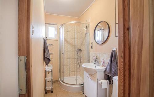 a bathroom with a shower and a toilet and a sink at Cozy Home In Morag With Lake View in Morąg