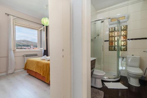 a bathroom with a toilet and a sink and a shower at Villa Bakica in Trogir