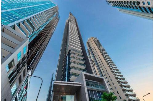 two tall buildings next to each other in a city at AAB Apartments Skyline in Brisbane